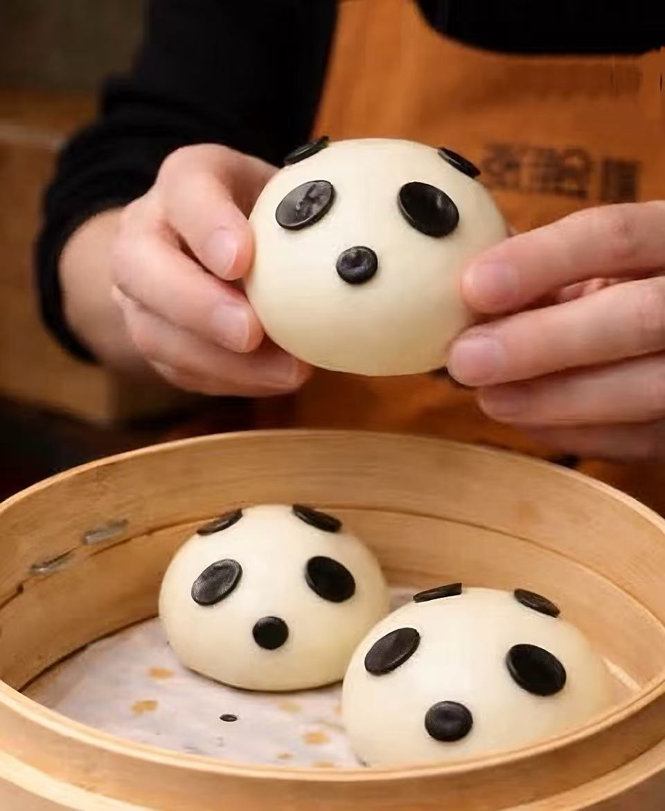 Bao decorati a forma di panda nel cestello di bambù